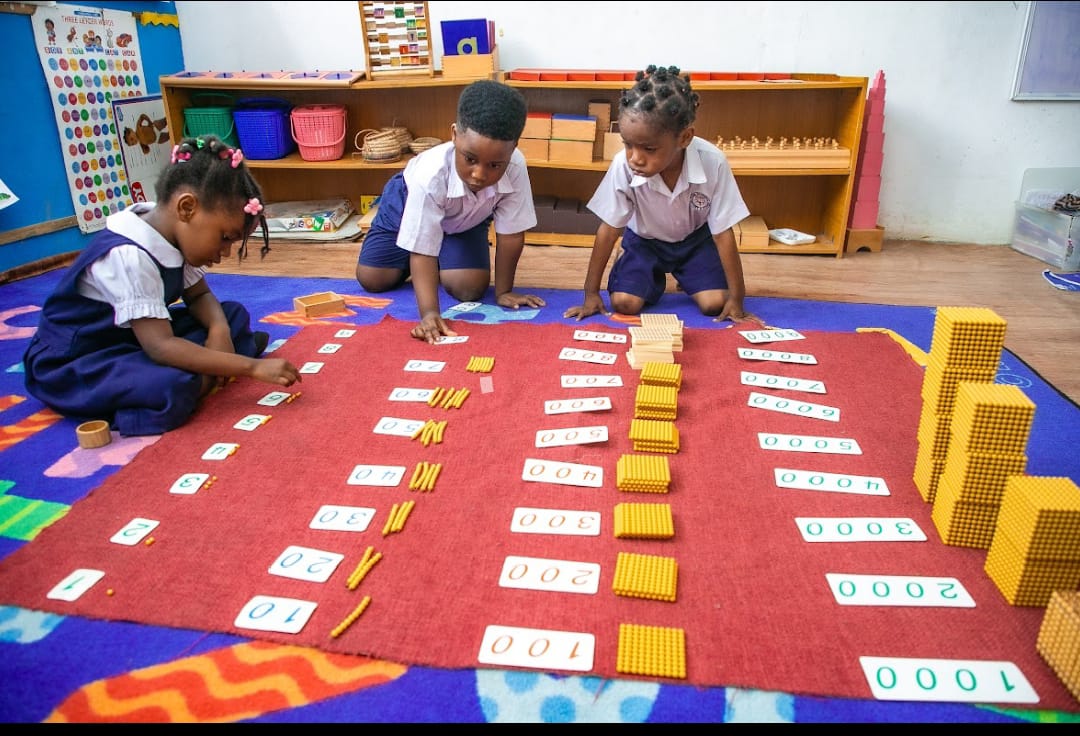 Children learning with Montessori number materials in a Montessori classroom at Ambassadors Bilingual School