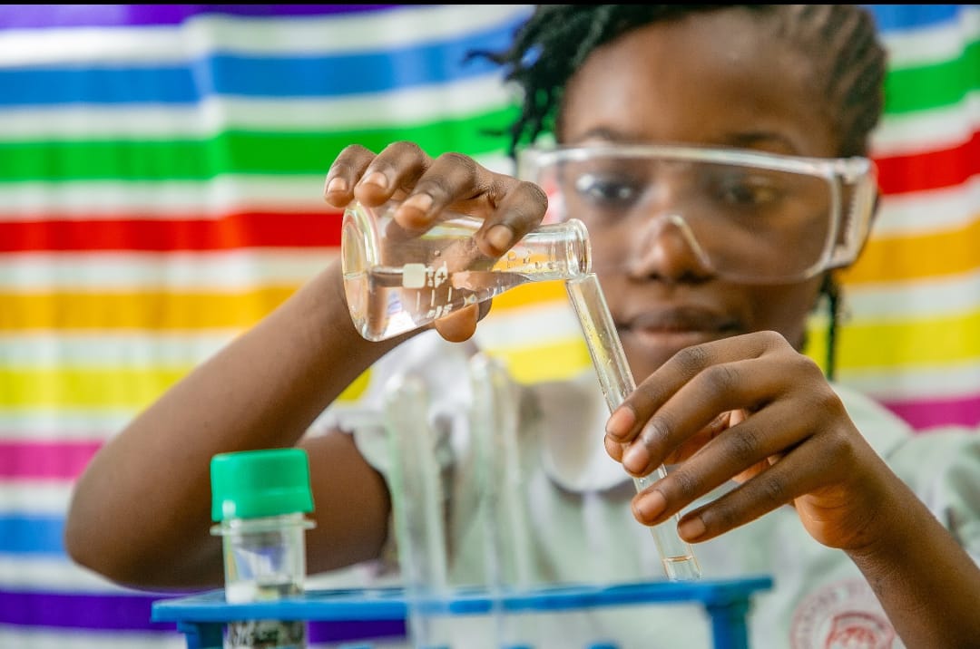 Pupil in safety goggles doing a science experiment at Ambassadors Bilingual School